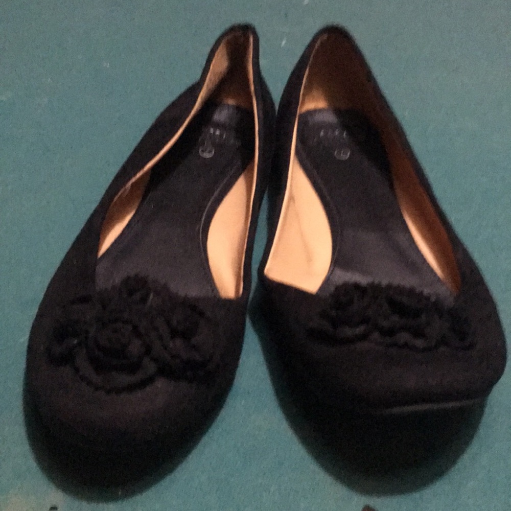 Black flats with a pretty flower detail on the toe